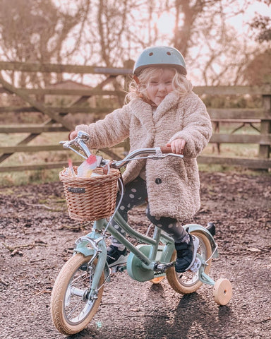 furry coat child on bobbin blue gingersnap bike matching helmet