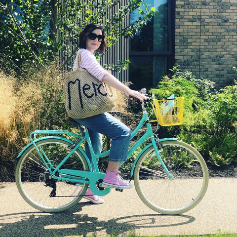 lady on a bobbin vintage bike with a merci bag